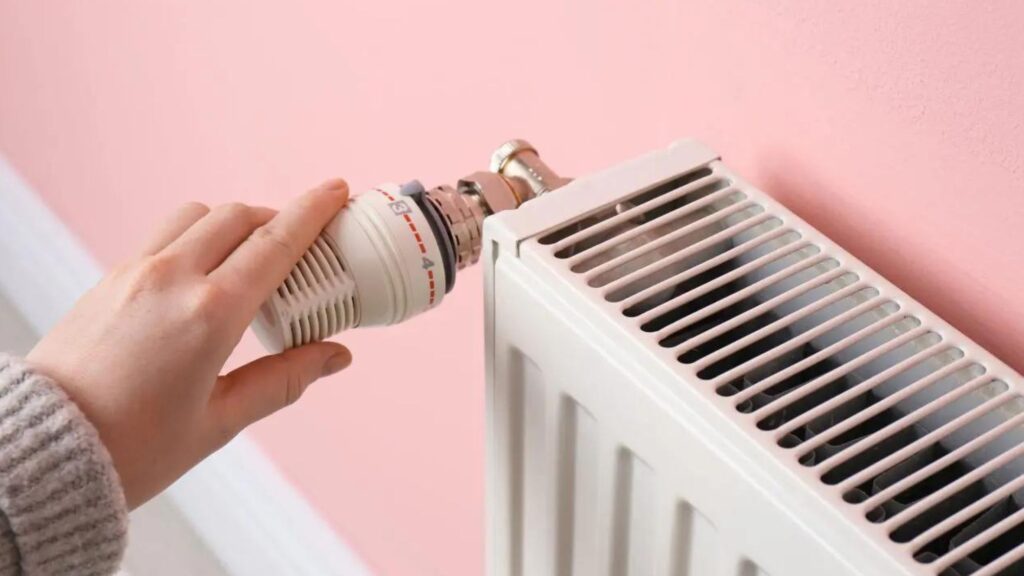 A woman turning off one of her home radiators